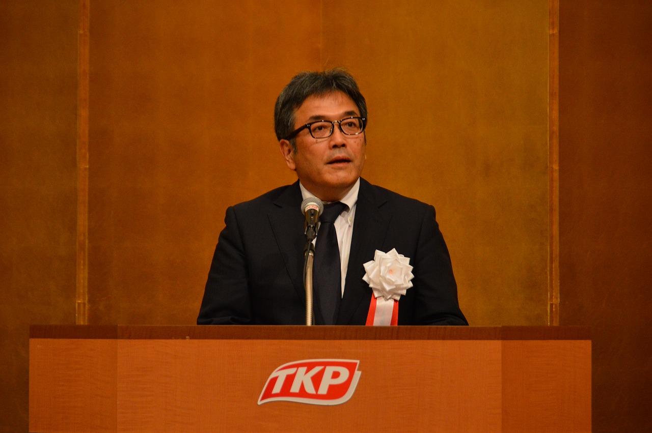 あいさつする高岡会長